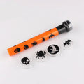 Orange metal pumpkin skull flashlight projection lamp on a plain background