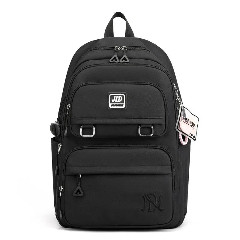 Girls' large nylon backpack in a solid colour showing curved back panel and front pocket.