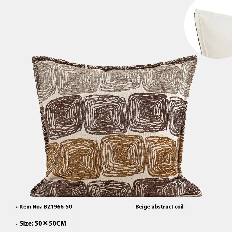 Cream and coffee coloured abstract coil pattern on a square cushion cover.