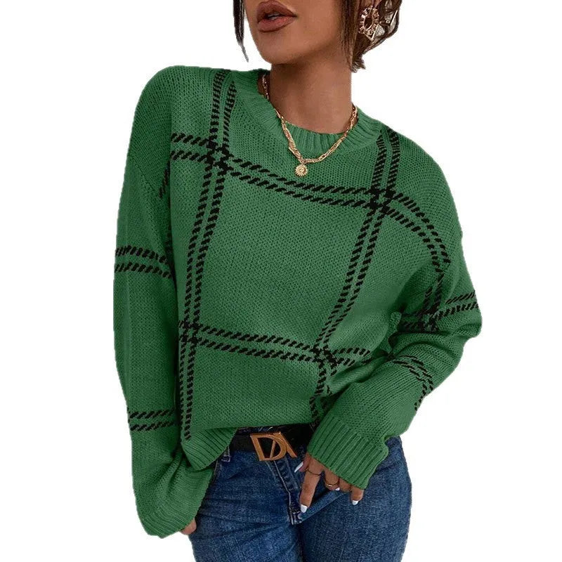 Women's apricot, black, beige, red and green plaid colour-block crew neck acrylic sweater on a hanger