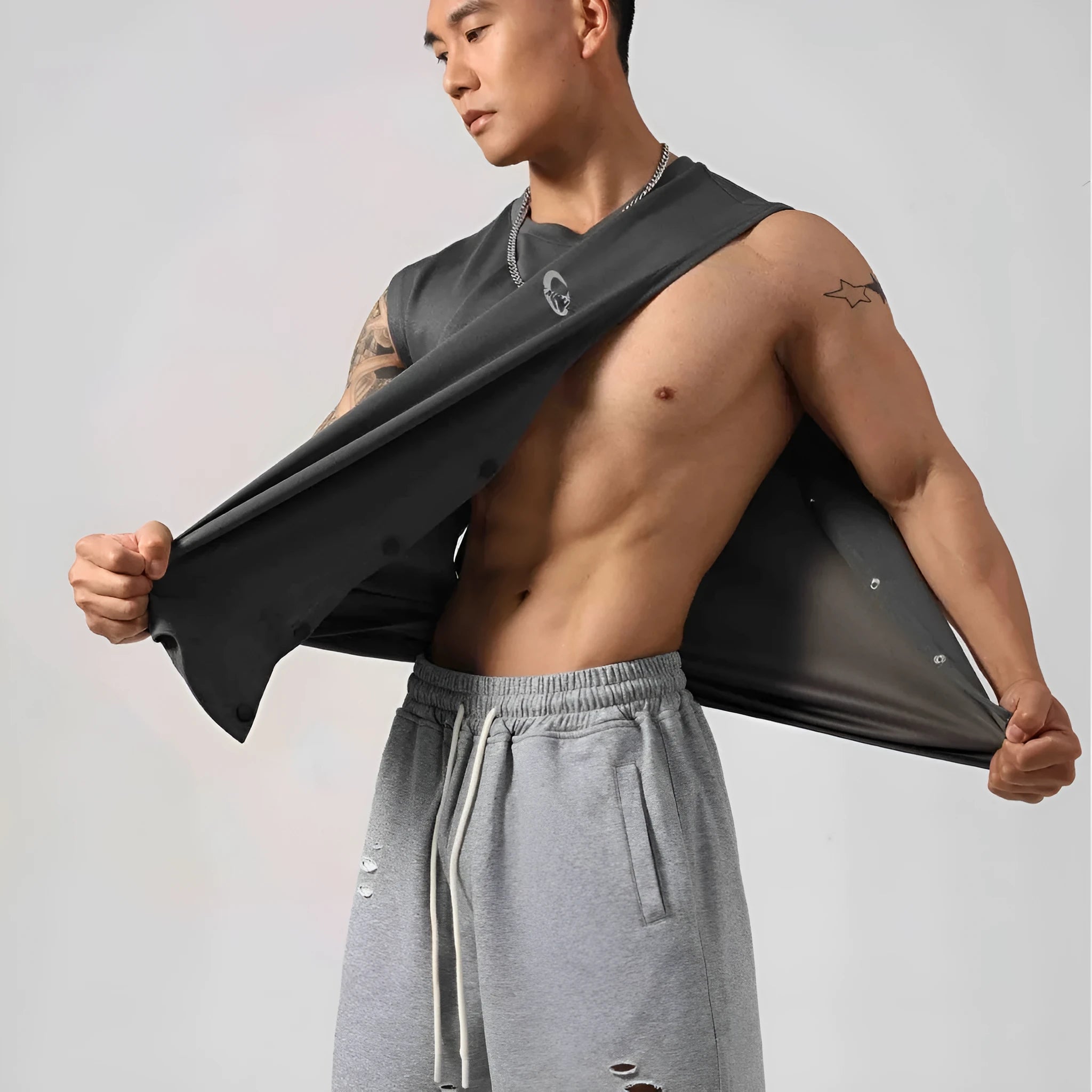 Male model wearing a solid colour loose fit cotton fitness vest with hidden side hooks.