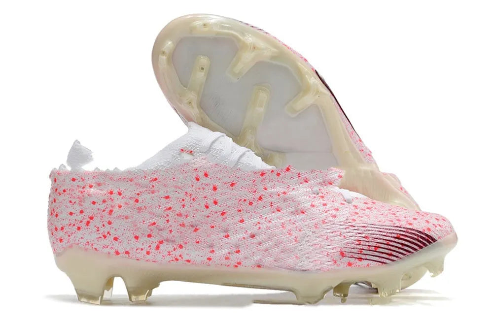 Men's low-top football shoes with knitted upper, rubber outsole with FG studs, shown in a front lace-up style.
