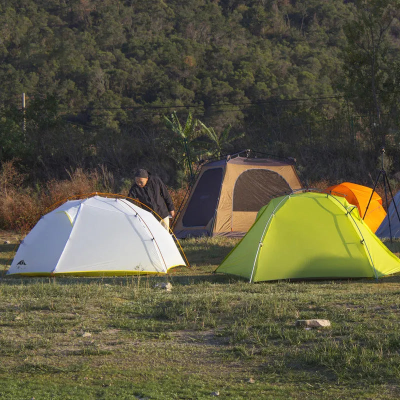 Green camouflage double layer camping tent with two room one hall layout set up outdoors
