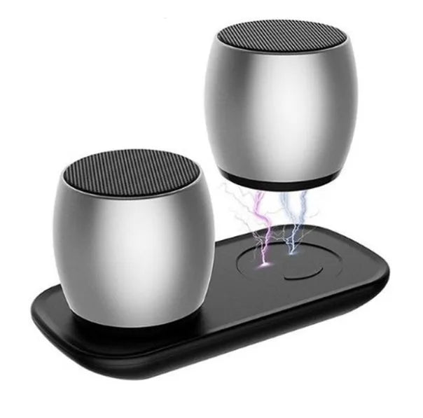 Creative Bluetooth speaker pair in black and silver on a charging base