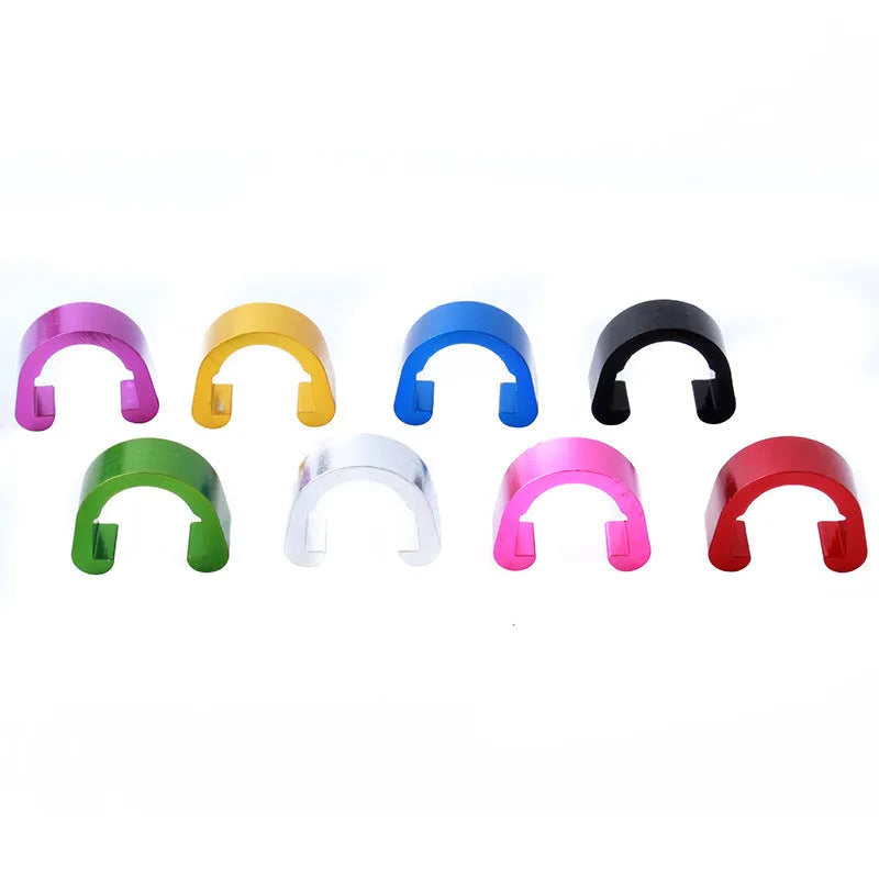 Ten small aluminium alloy C-shaped buckles in assorted colours on a white background.