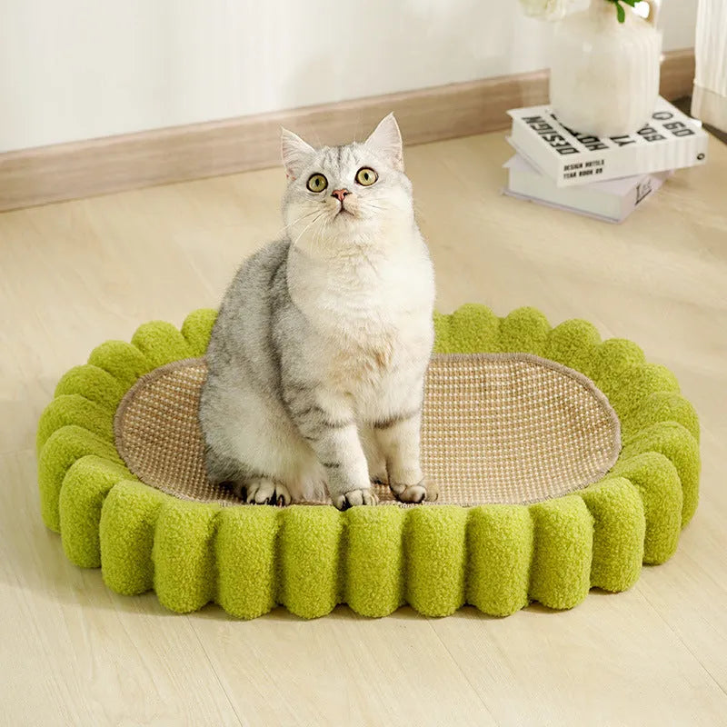 Green oval-shaped cat scratching pad serving as a bed with a sisal surface