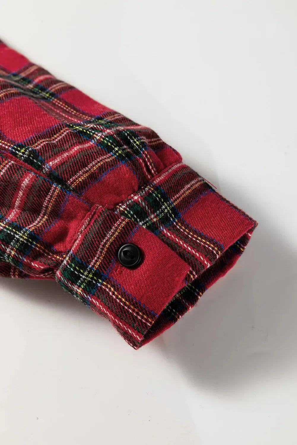 Red plaid mini dress with shirt collar, half-button front, long sleeves, and ruffle hem detailing