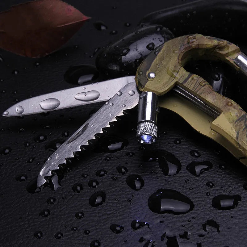 Camouflage multifunctional carabiner with knife, saw, and LED light on a black background