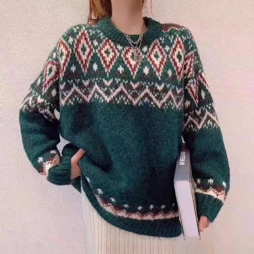 Red and white striped loose-fit knitted pullover with long sleeves on a model.