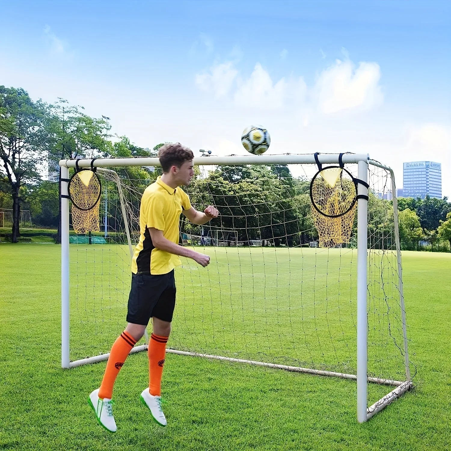 Black portable soccer training goal net with fibreglass poles set up on grass for practice.