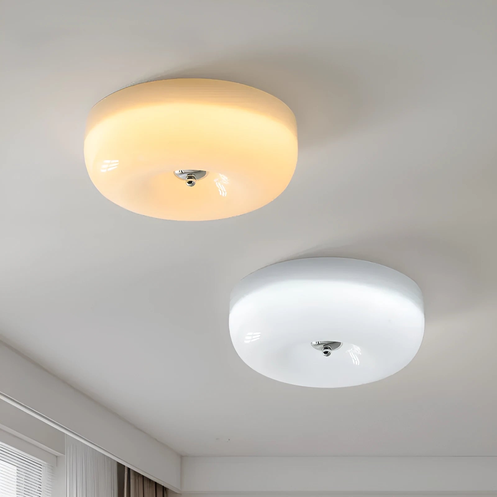 Creamy yellow and white opal shade ceiling light with remote control on a bedroom ceiling.