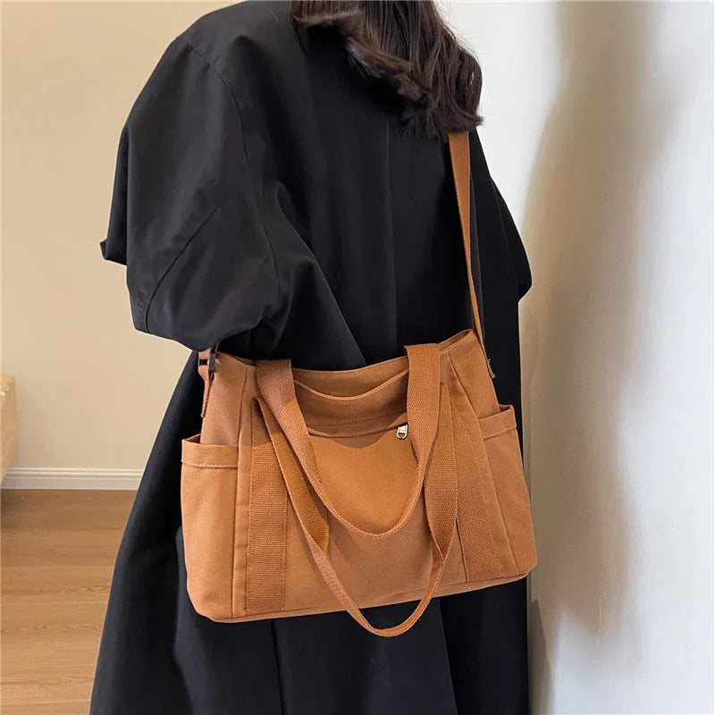 Large solid colour polyester shoulder tote bag with external pocket and internal phone compartment