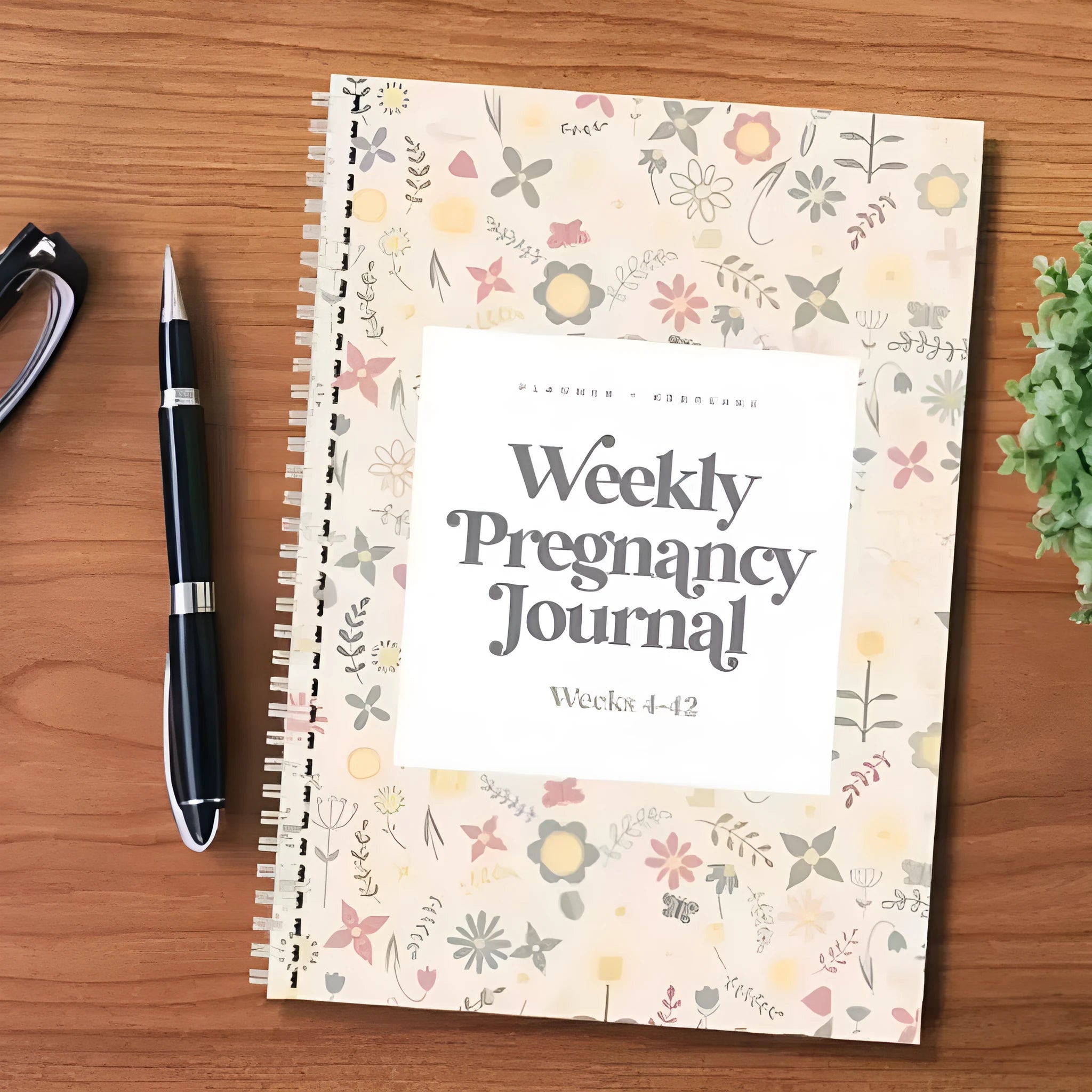 A5 size weekly pregnancy diary notebook open on a page showing weekly layout