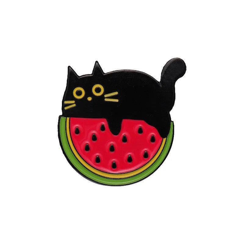 Close-up of a colourful cartoon strawberry metal brooch with a safety-pin clasp, on a denim jacket pocket.