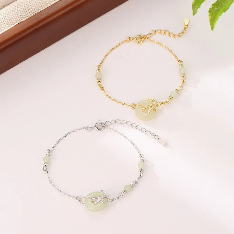 Antique style women's 925 silver bracelet with a peace buckle and safety clasp on a jewellery tray.
