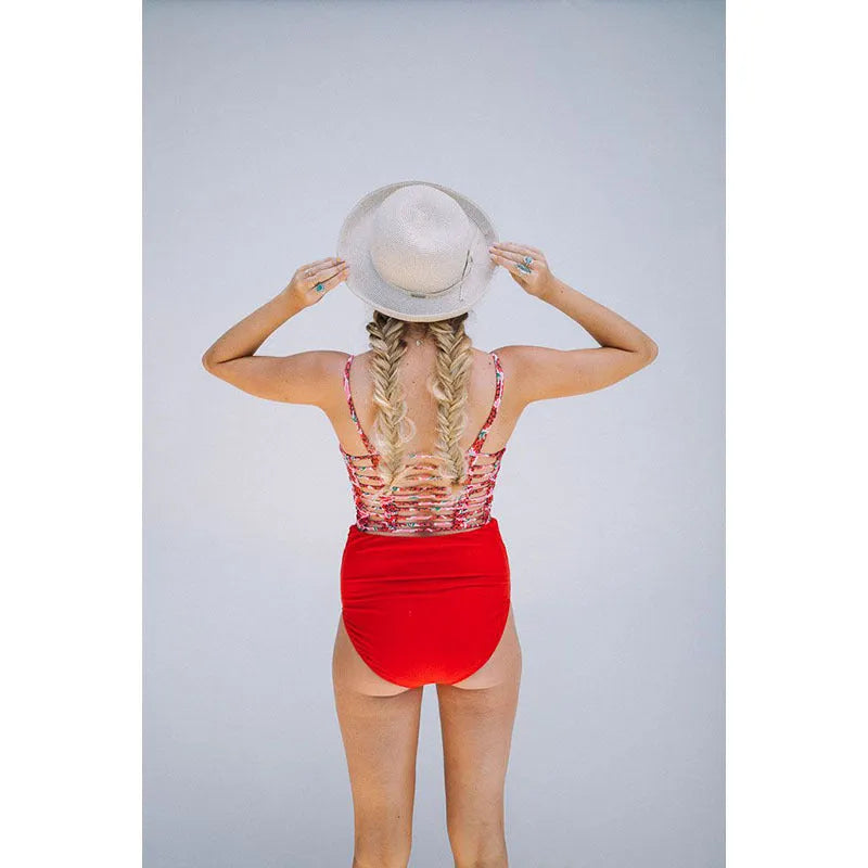 Red high waist maternity swimsuit with matching swim trunks on a pregnant woman