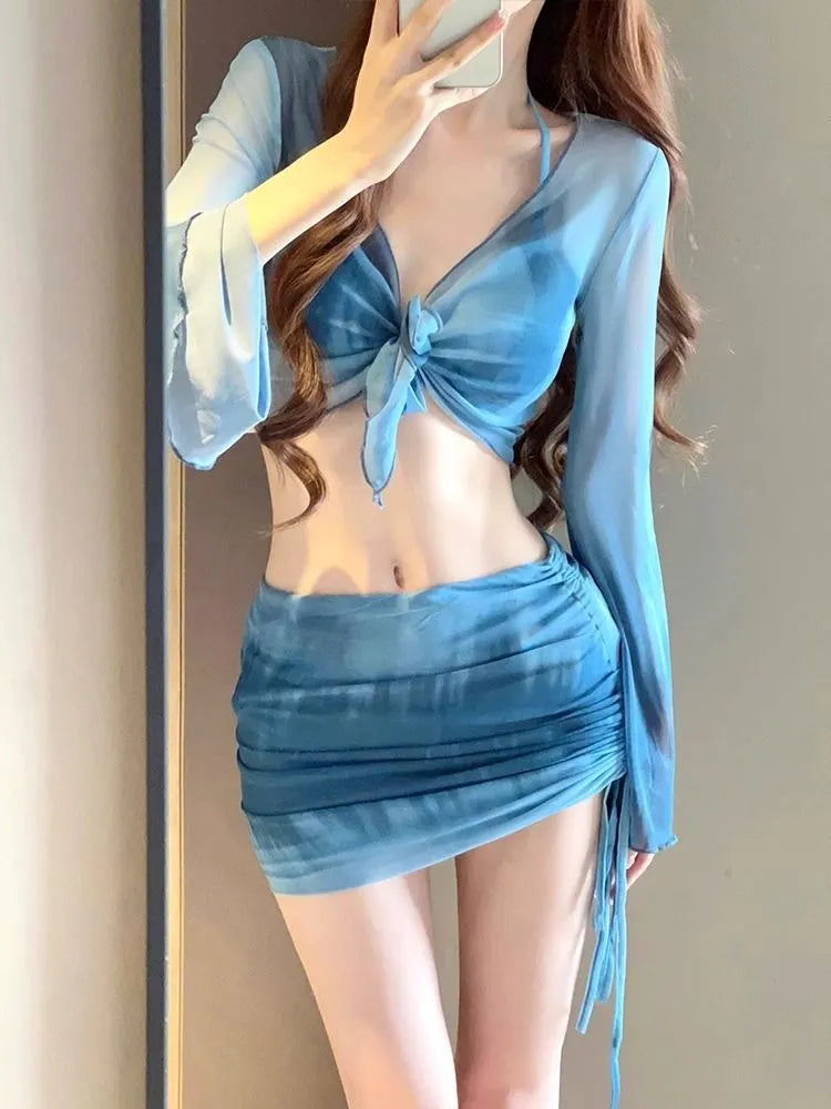 Women's blue high-waisted bikini four-piece set with shirt and skirt on a mannequin