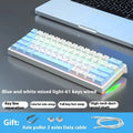 Compact bluish-black 61-key wired mechanical keyboard with hot-swappable switches on a desk.