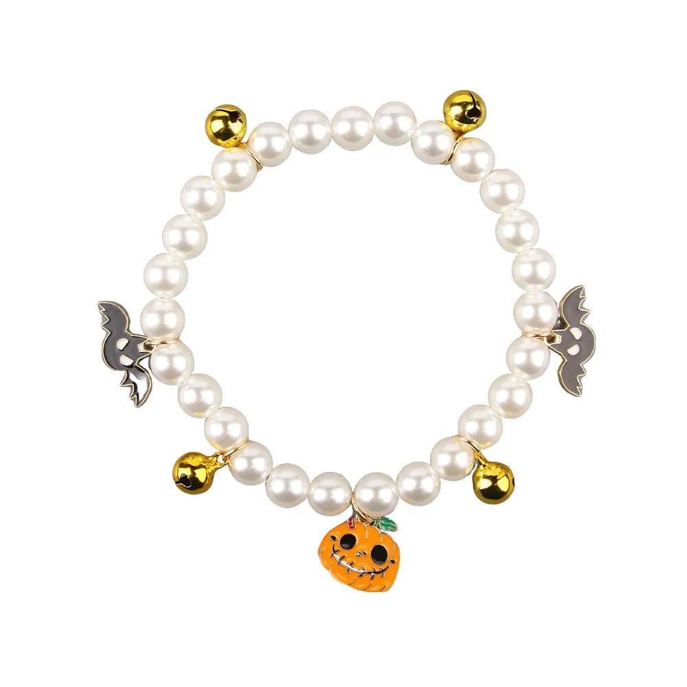Decorative Halloween cat collar with simulated pearls and pumpkin charm in purple ghost design