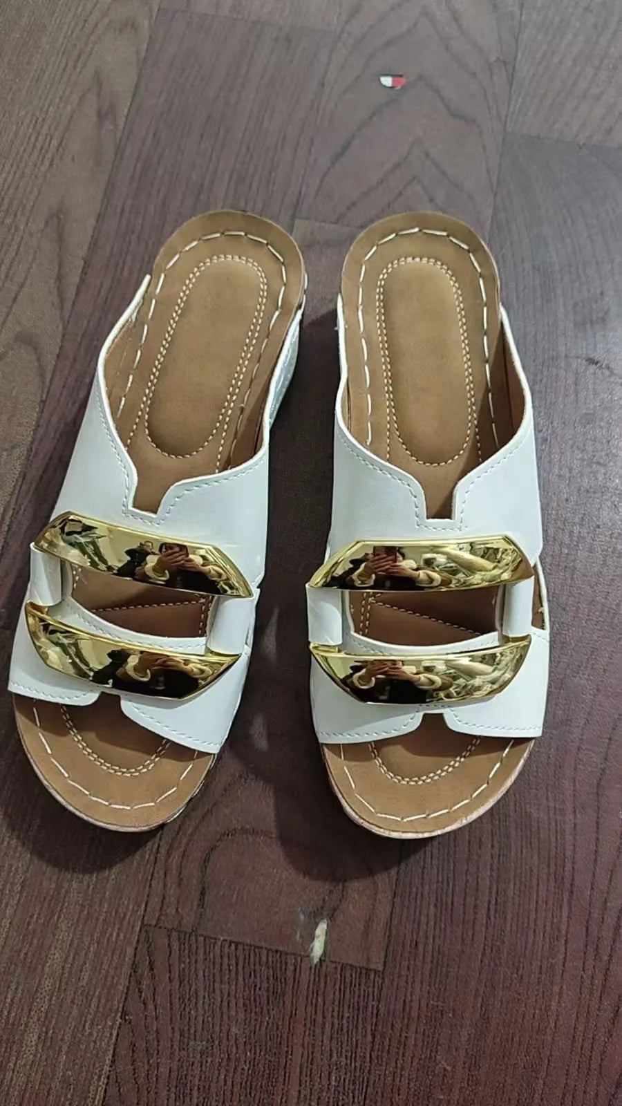 Roman style platform sandals in white, black, khaki, and blue on a solid colour background.