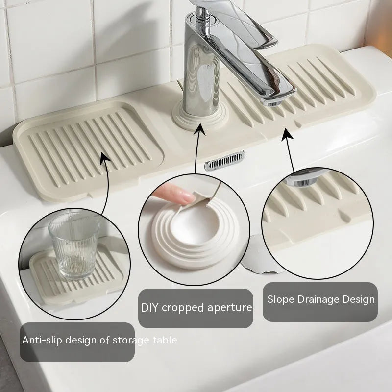 Silicone faucet splash guard mat in a choice of colours, showing sloped design with drain channels, placed around a sink faucet base.
