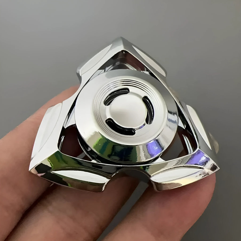 Close-up of a silver and colourful alloy metal fingertip gyro decompression spinner toy.