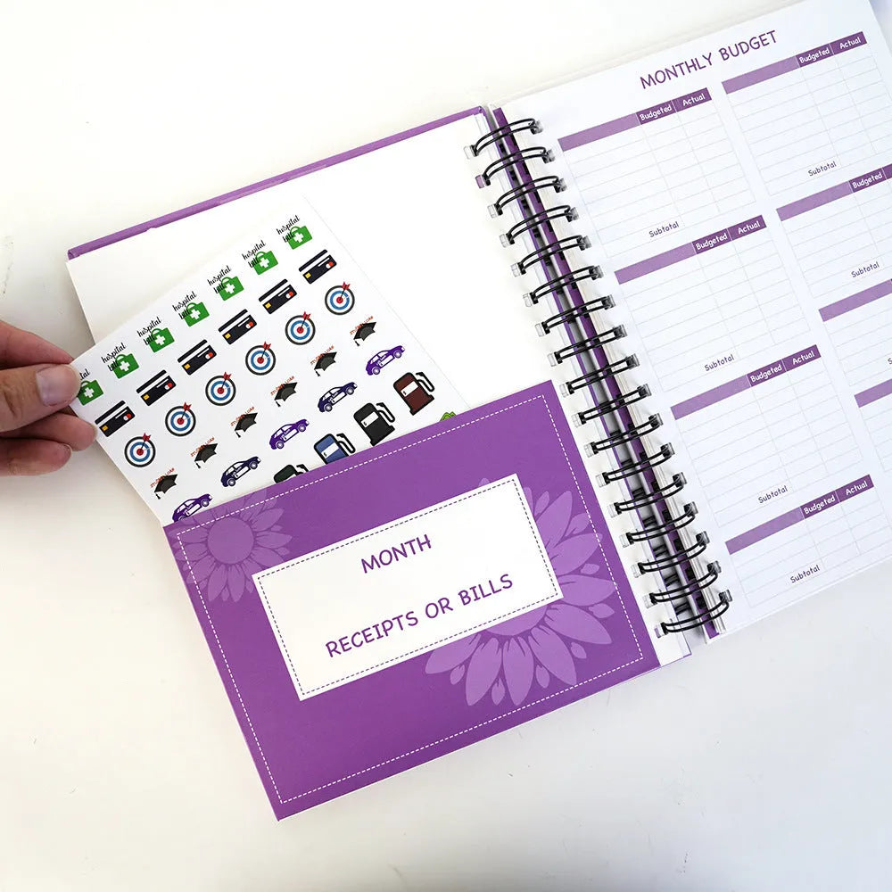 Purple A4 coil notebook for financial planning with budget pages, pen and accessories