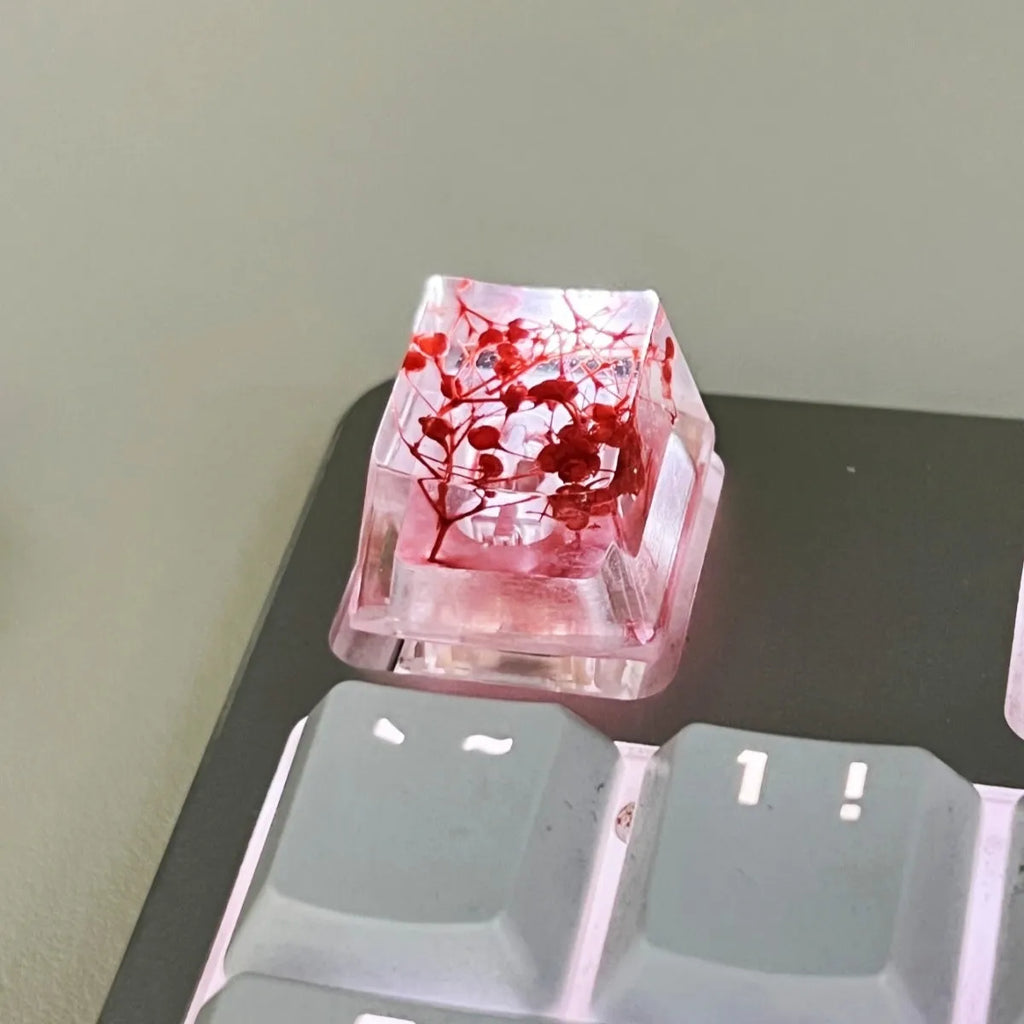 High transparency resin keycap with starry sky pattern in green, shown next to a mechanical keyboard.