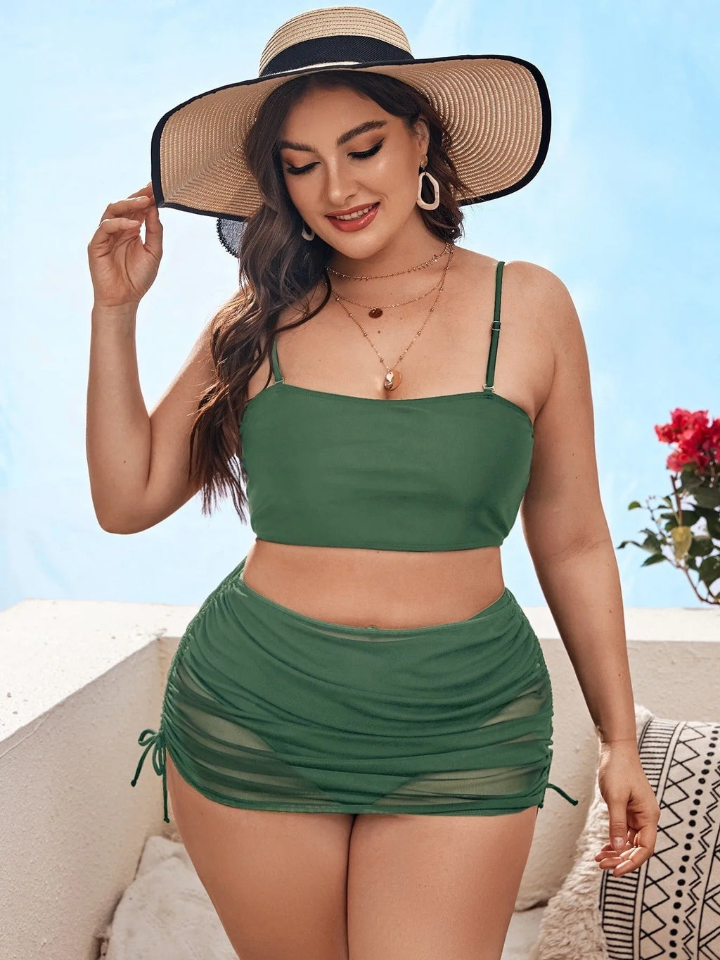 Women's solid colour mesh bikini three-piece set with apron on a mannequin.