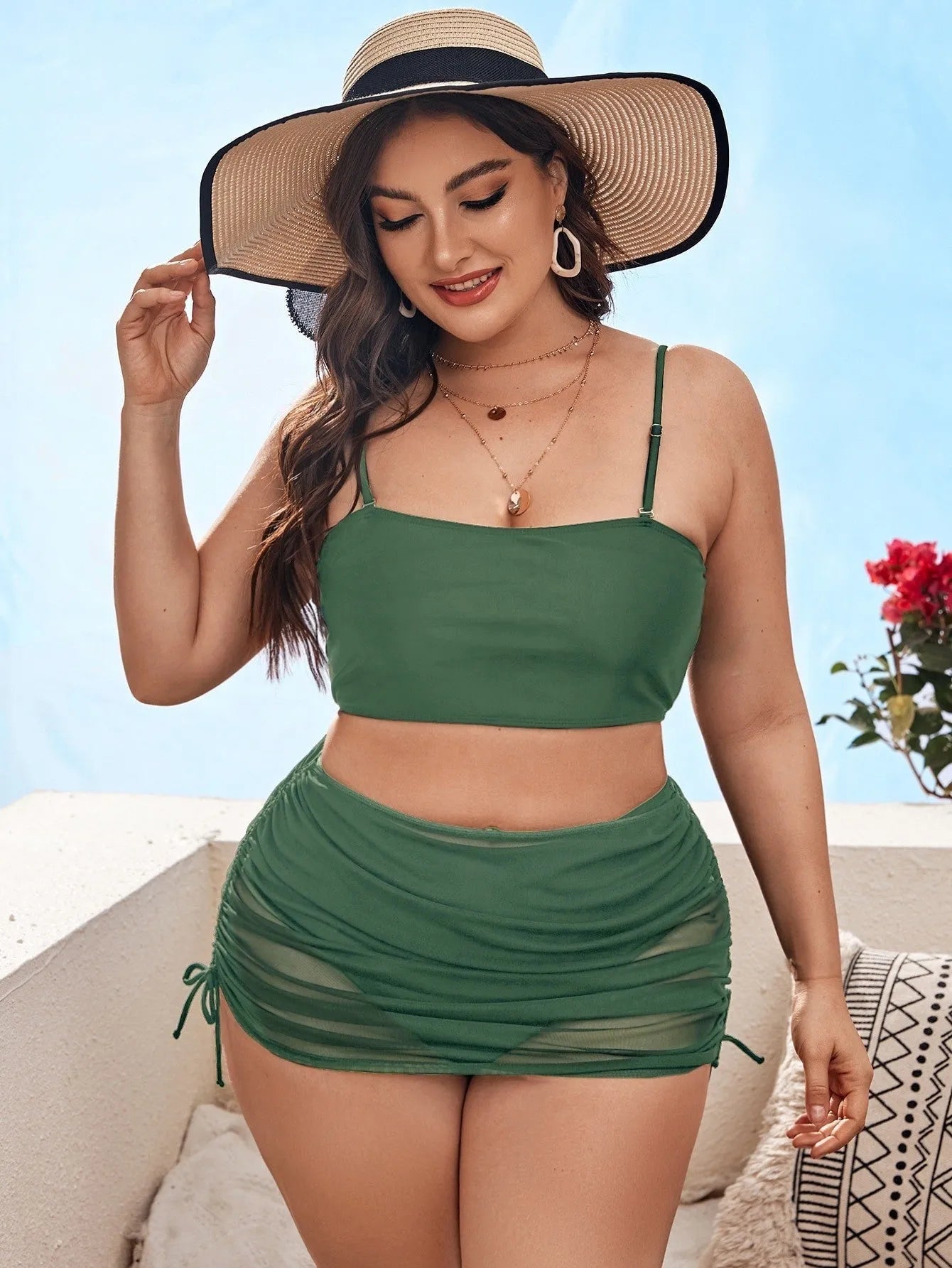 Women's solid colour mesh bikini three-piece set with apron on a mannequin.