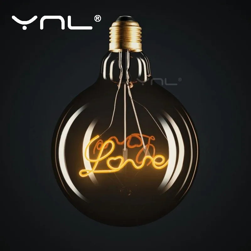 Yellow LOVE letter lamp with glass lampshade emitting warm light, 125x175mm on a tabletop