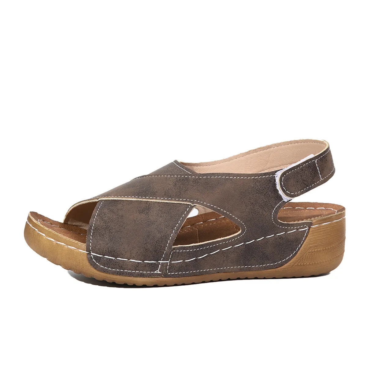 Women's brown roman platform sandals with a skirt detail and Velcro strap closure on a white background.