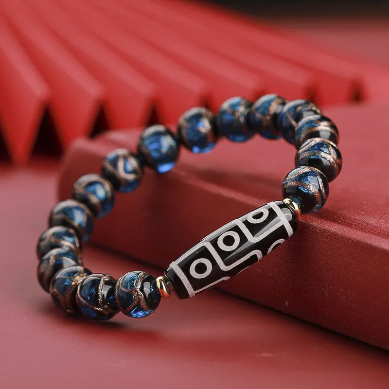 Close-up of a handcrafted coloured glaze bracelet with multi-colour lucky beads and auspicious Chinese patterns.