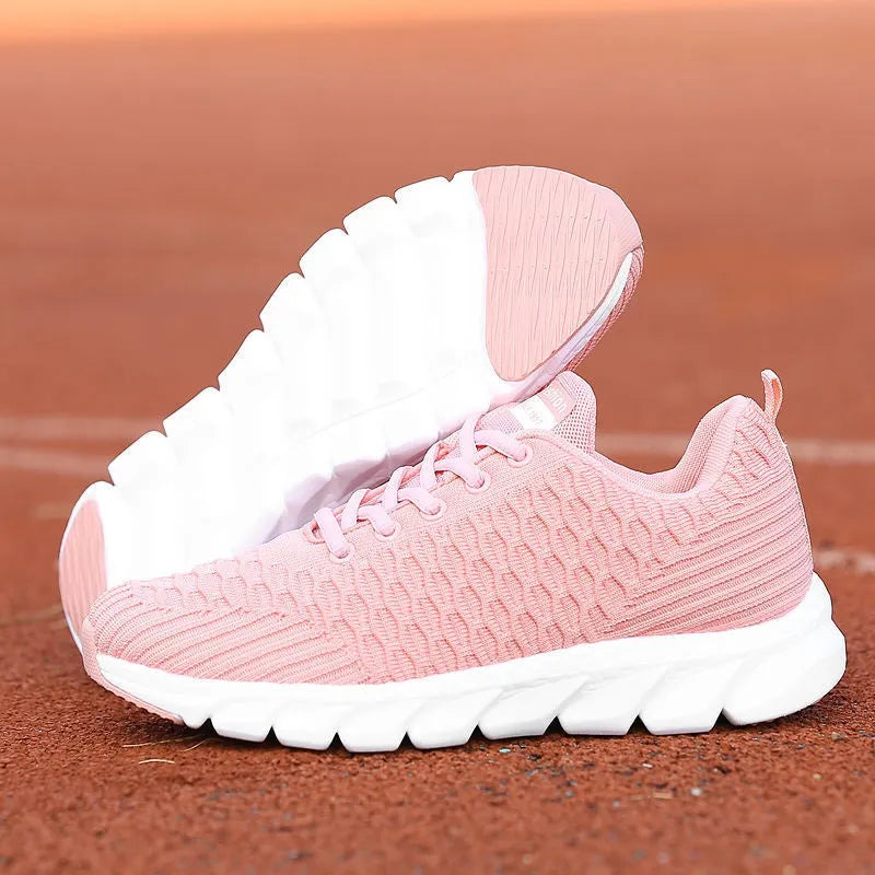 Women's running shoes in black, pink, or white with fly weave upper and durable outsole.