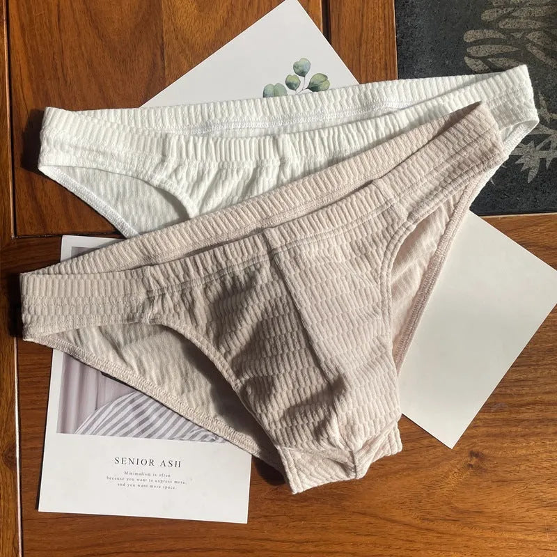 Men's triangle underwear briefs in solid colours showing cotton fabric texture and mid waist design