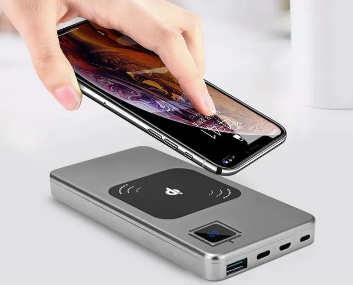 Portable power bank charger with LCD display in alloy casing showing black, silver, red, and blue colour options