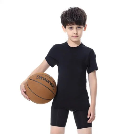 Children's black and green sportswear set showing T-shirt, trousers, and shorts on a size chart.