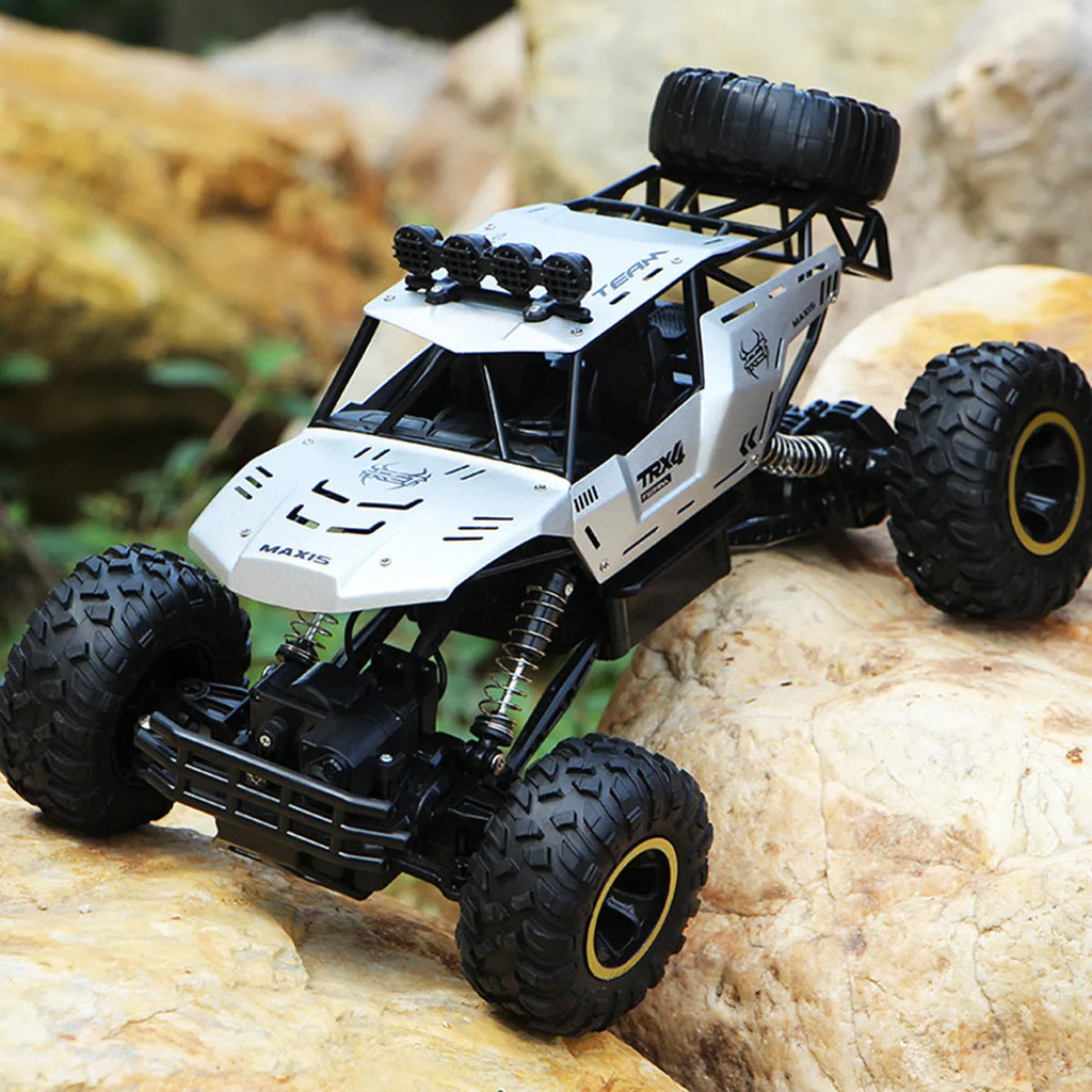 Large black 4WD remote control off-road climbing car on rough ground