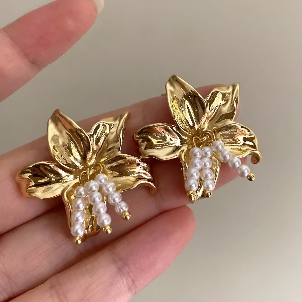 Golden metal flower earrings with exaggerated design and personalised pearl elements