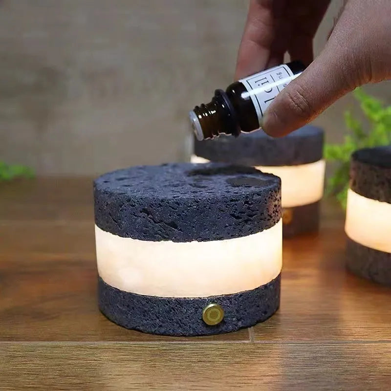 Small orange volcanic rock touch lamp with USB port and essential oil well in warm white.