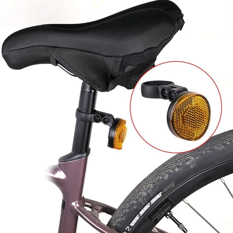 Red plastic anti-theft bicycle taillight bracket mounted on a bike seat post.