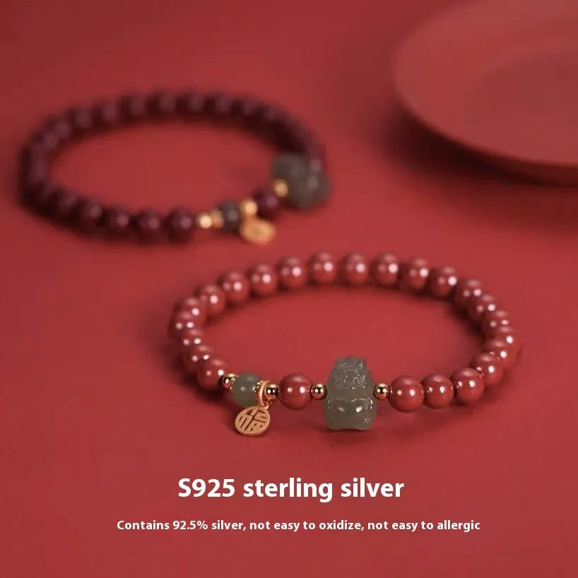 Natural Hetian Jade bracelet with animal modelling in Emperor Sandstone style.