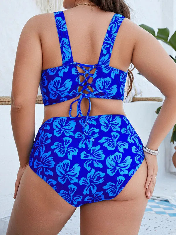 Blue floral print women's plus size bikini top and pants on a neutral background.