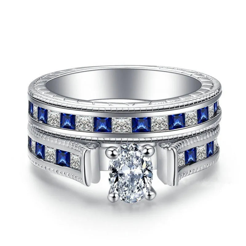 Blue alloy couple ring set with white diamond-style detail on white background