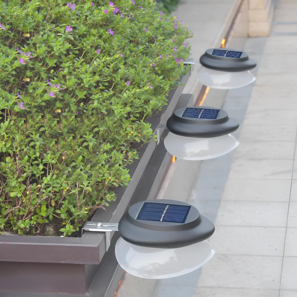 Solar-powered outdoor fence wall lamp with Southeast Asian design mounted on garden fence