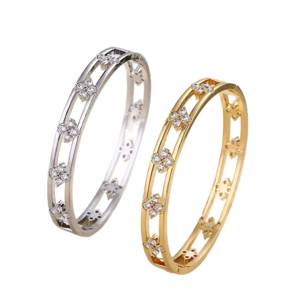 Gold and silver hollow women's bracelet with zircon four-leaf clover and grass petal charm.
