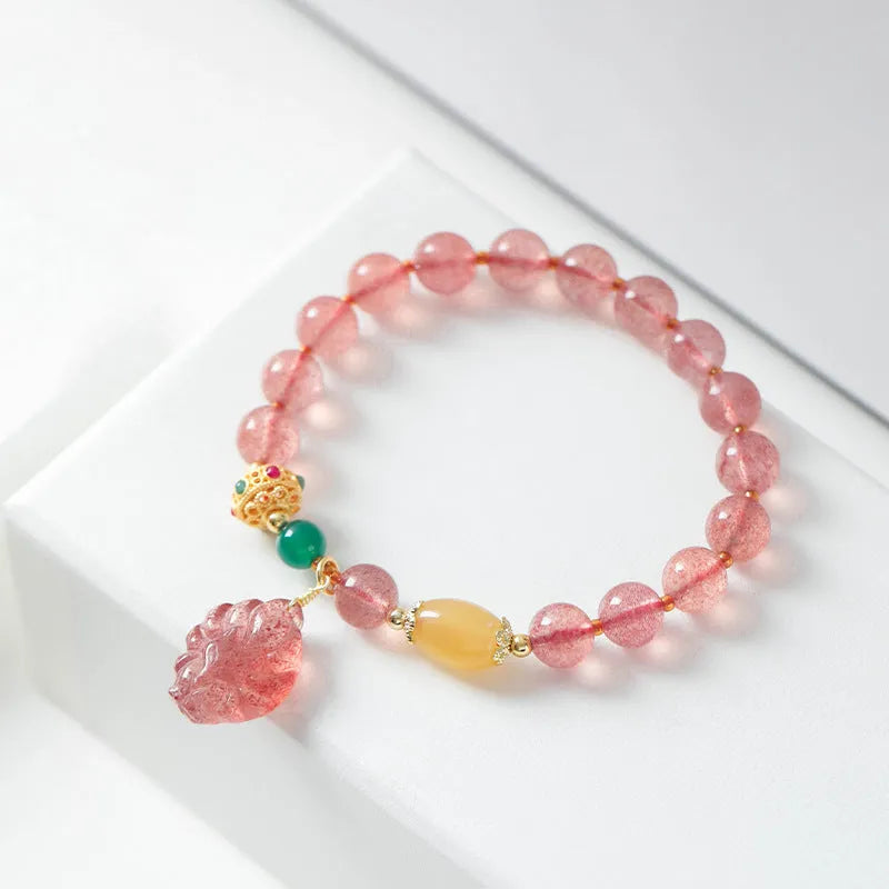 Women's Nine Tail Fox style strawberry quartz crystal beaded bracelet on wrist