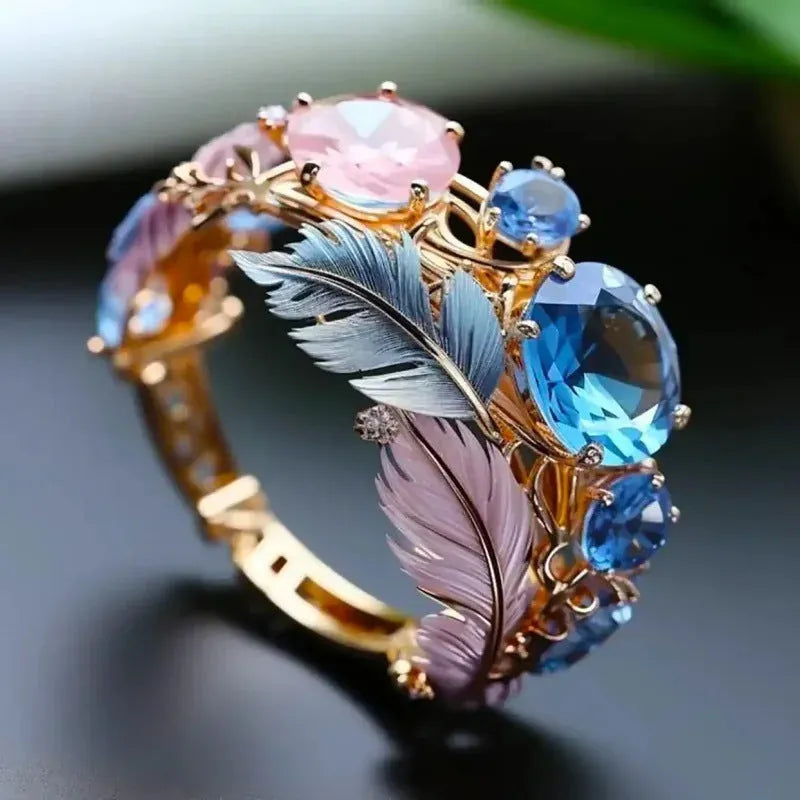Geometric brass feather ring with zircon inlay in gold colour