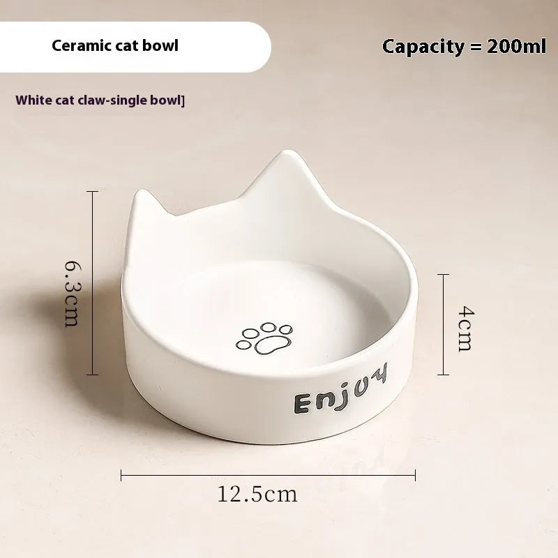 Porcelain cat bowl with cat ear and paw design on a wooden feeding frame, in pink colour.