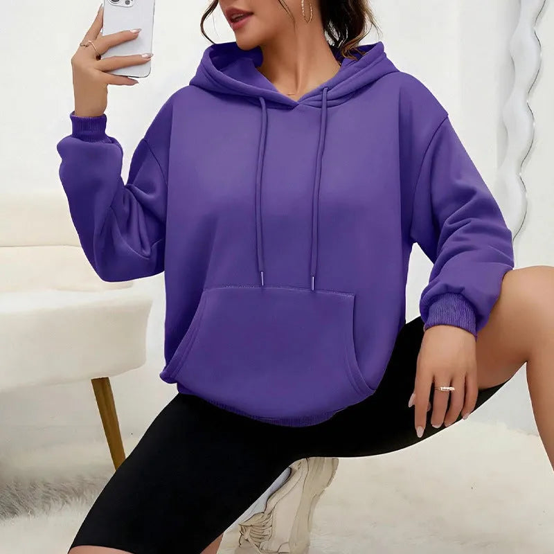 Loose fit women's drawstring hoodie in a choice of multiple colours on a hanger.